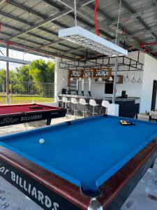 a pool table in a room with a bar at Shukran Habibi Resort in Santa Rita