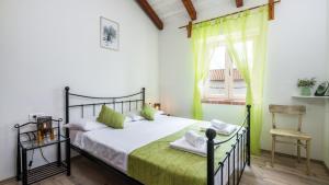 a bedroom with a bed and a chair and a window at Villa Katja by Villas Guide in Peruški +35 photos