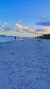 a group of people on a sandy beach at Verde & Sal 14 in Ilhéus