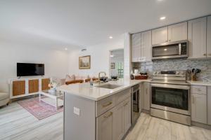 a kitchen with a sink and a stove top oven at Le Malo Vacation Rental in Naples +12 photos