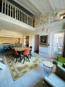 a living room with a table and chairs at Aube du Tilleul in Lagorce