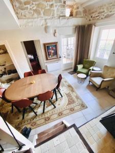 a living room with a wooden table and chairs at Aube du Tilleul in Lagorce +17 photos