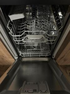 an empty dish rack in a dishwasher at La Cabine Noire - Foppolo in Foppolo