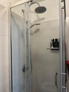 a shower with a glass door in a bathroom at La Cabine Noire - Foppolo in Foppolo +18 photos