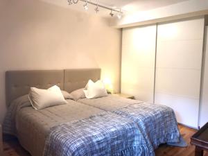 a bedroom with a bed with two pillows on it at Espacioso e independiente apartamento in Las Rozas de Madrid