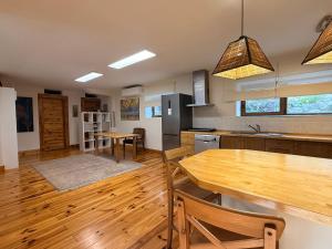 a kitchen with a wooden table and a wooden floor at Espacioso e independiente apartamento in Las Rozas de Madrid