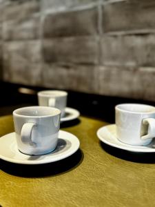 three cups and saucers sitting on a table at Rosetta - Ai Meli - Dolomites in Lozzo Cadore +35 photos