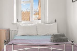 a bed in a room with a window at Badger Haven, Apartment 1 in Brackley