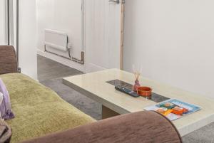a living room with a table and two chairs at Badger Haven, Apartment 1 in Brackley