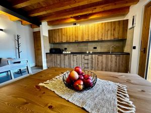 a bowl of fruit on a table in a kitchen at Rosetta - Ai Meli - Dolomites in Lozzo Cadore