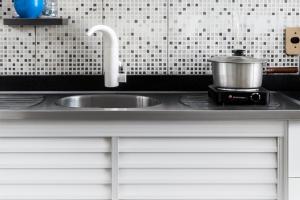 a kitchen sink with a pot on a stove at Quarto - Room Econômico da Maricotinha - No Air Cond in Manaus