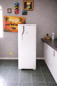 a white refrigerator in a kitchen next to a counter at Quarto - Room Econômico da Maricotinha - No Air Cond in Manaus