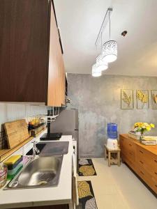 a kitchen with a sink and a counter at Cozee Staycations in Lapu Lapu City
