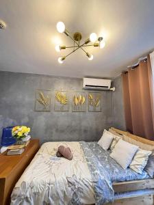 a bedroom with a bed and a ceiling fan at Cozee Staycations in Lapu Lapu City +12 photos