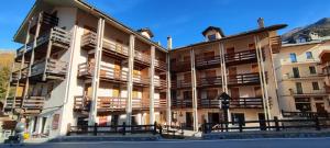 a large building with balconies on the side of it at Sant'Orso Cozy Home in Cogne