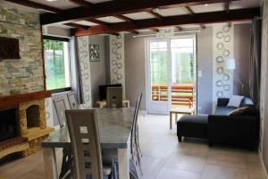 a living room with a table and a couch at La croix majot in Regniowez