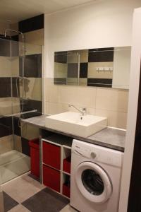 a kitchen with a washing machine and a sink at La croix majot in Regniowez +19 photos