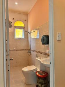 a bathroom with a toilet and a sink at Phú Quốc STAR hotel in Phú Quốc