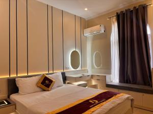 a bedroom with a bed and a window at Phú Quốc STAR hotel in Phú Quốc +12 photos