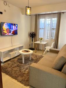 a living room with a couch and a table at Stylish 1br Milimani in Kisumu