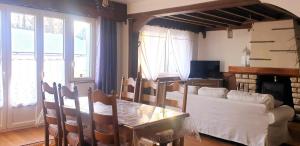 a living room with a table and a couch at Le lavoir in Moiry
