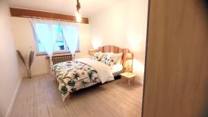 a bedroom with a bed and a window at Le lavoir in Moiry