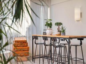 a table with chairs and plants on top of it at B&B HOTEL Eurorest Conegliano in Conegliano