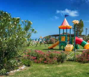 a park with a playground with a slide at Acacia Resort in Campofelice di Roccella