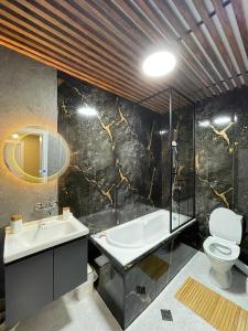a bathroom with a sink and a toilet and a tub at BM Aparts Rustic in Pleven +29 photos