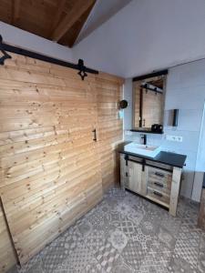 a bathroom with a sink and a wooden wall at Casa Laryssiou in Gythio +56 photos