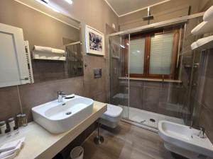 a bathroom with a sink and a shower and a toilet at Guest House Seataly - by Be Your Home in Civitavecchia +43 photos
