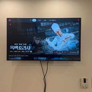 a flat screen tv hanging on a wall at COZY stay in Seoul