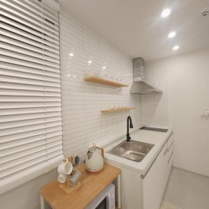 a small kitchen with a sink and a counter at COZY stay in Seoul +30 photos