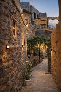 a stone building with lights on the side of it at بيت العريش Arish house in Sayq
