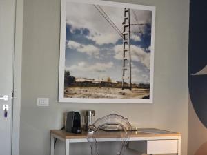 a picture hanging on a wall above a table at Guest House Seataly - by Be Your Home in Civitavecchia