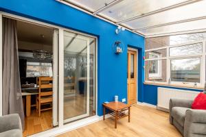 a living room with a blue wall at Dreelside - No 50 in Anstruther