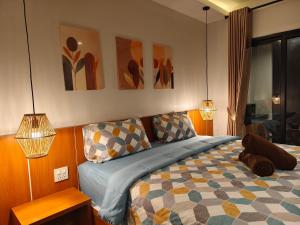 a bedroom with a bed and some paintings on the wall at Ingtara at Lanta in Ko Lanta