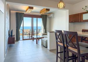 a kitchen and living room with a view of the ocean at Arabela 2 Apartments in Utjeha