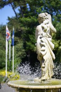 a statue of a girl sitting in a fountain at Best Western Abbots Barton Hotel in Canterbury +78 photos