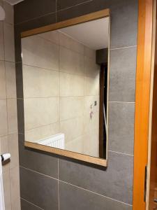 a mirror on a wall in a bathroom at Chata Maruska in Ružomberok +13 photos