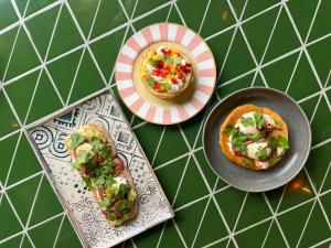 a table with two plates of food and a sandwich at Boavista 83 Hostel Lisbon in Lisbon +49 photos
