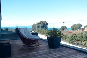 a balcony with a hammock and potted plants at Bloom - Beach House in Apúlia