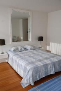a bedroom with a large bed with a large mirror at Bloom - Beach House in Apúlia +23 photos