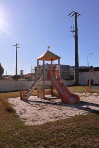 a playground with a slide and a play structure at Bloom - Beach House in Apúlia
