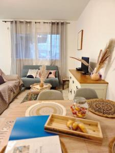 a living room with a table and a couch at FELTON - Appartement 2 pers Dinan in Dinan