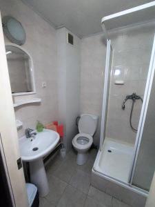 a bathroom with a toilet and a sink and a shower at Motel Poltava in Poltava
