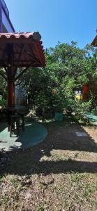 a park with a picnic table and a umbrella at Verde & Sal 12 in Ilhéus