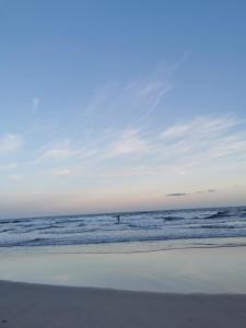 a person is in the water at the beach at Verde & Sal 12 in Ilhéus