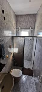 a bathroom with a shower and a toilet and a sink at Verde & Sal 12 in Ilhéus