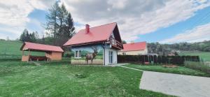 a house with a painting of a deer on the side of it at Domek Na Hawajach in Polana